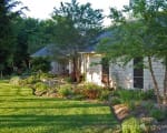 Curved beds and native Texas plantings give a country property charm and appeal Country property front landscape