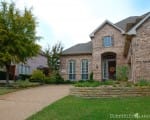 Removal of overgrown builder grade shrubs opens up the entrance and makes the home more welcoming Front yard in Plano, Texas